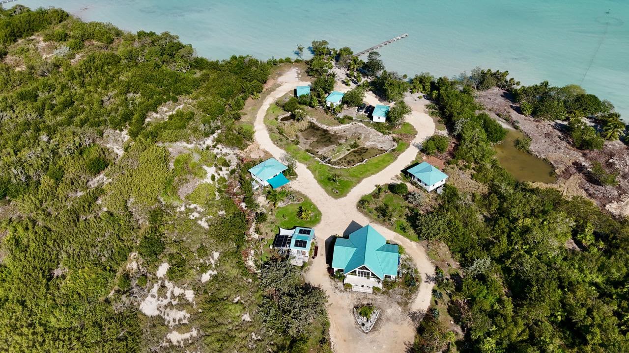 Aerial view of Belizima’s turquoise-roofed buildings, grounds, and waterfront.
